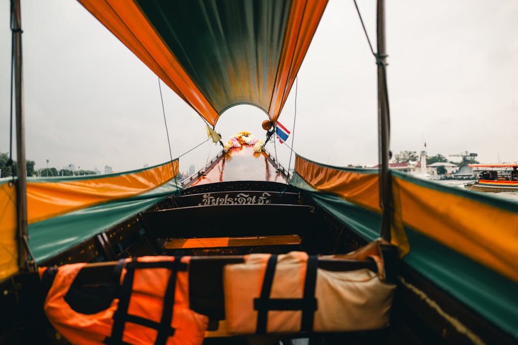 Experience the vibrant culture of Bangkok from a traditional longtail boat cruising along the river.